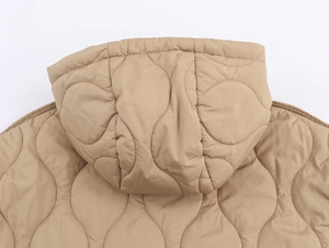 Détail d'une veste à capuche kaki avec surpiqûres en forme d'oignon et finitions de qualité