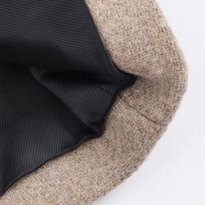 Detailed close-up showing khaki wool fabric texture and durable black diagonal lining