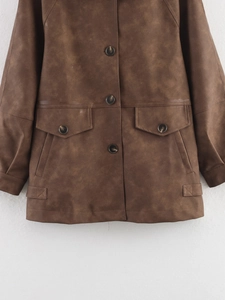 Detail of a brown faux suede jacket featuring vintage flap pockets and button closure