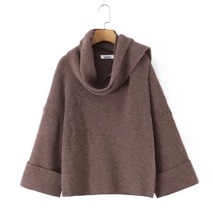 Close-up of brown knit sweater featuring heavy ribbed texture and wide folded cuffs