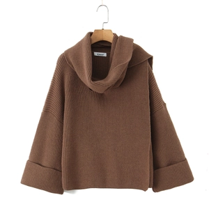 Detail of loose dark coffee knit sweater featuring a turtleneck and ribbed texture
