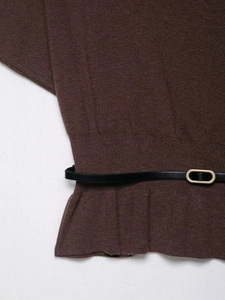 Detailed view of dark coffee knit sweater featuring a black leather belt with gold buckle