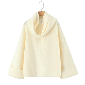 Close-up of the oversized cream chunky knit sweater featuring a thick turtleneck collar