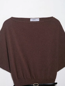 Detail view of a brown boat neck knit top with thin black belt and soft texture