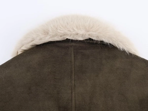 Detail of the winter jacket's plush faux fur collar and deep brown textured wool fabric