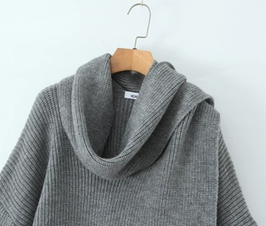Close-up of the chunky grey knit sweater featuring a thick turtleneck and woven texture