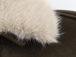 Detail of soft cream faux fur collar on dark olive winter jacket with plush texture