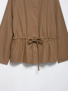 Detailed view of khaki jacket waist featuring adjustable drawstring and bow tie detail