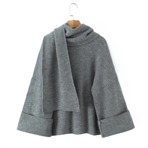 Detail of grey knit sweater showing scarf collar and ribbed texture on white background