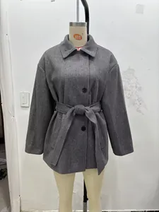Close-up of lapel collar and single-breasted black buttons on grey wool blend coat