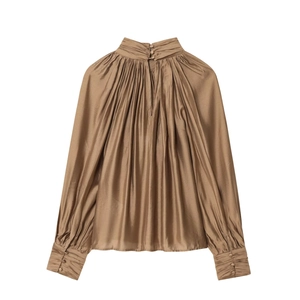 Detail of elegant pleated neckline and copper satin fabric with silk-like metallic luster