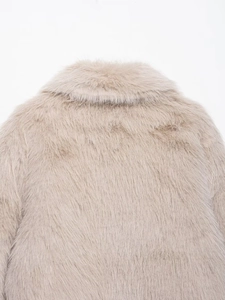 Detailed view of the thick plush faux fur collar and back seam on this beige jacket