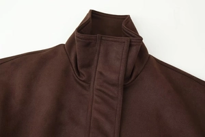 Detailed view of the dark brown suede texture and high collar stitching on jacket