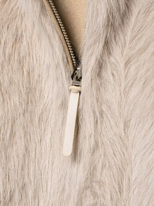 Detailed macro view of the premium metallic zipper and plush faux fur texture on a jacket
