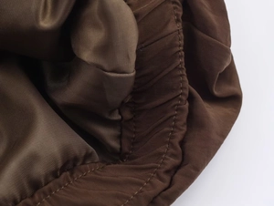 Detailed close-up of dark brown ribbed jacket lining with high-quality elastic stitching