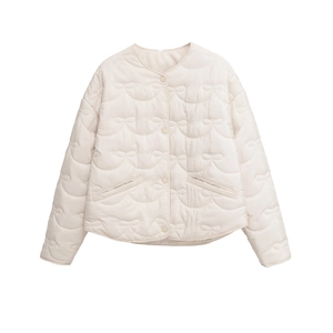 Detail of cream quilted jacket with unique bow-pattern stitching and button closure