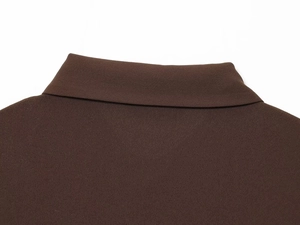 Détail du col à revers marron foncé avec une texture grainée et des coutures précises