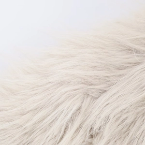Close-up of premium cream faux fur texture showing soft and dense long fibers