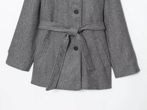 Detail of grey wool blend coat with single-breasted buttons and tied waist belt