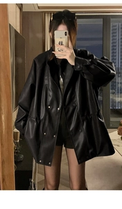 Close-up of black PU leather jacket featuring double-breasted metal buttons and drawstring waist