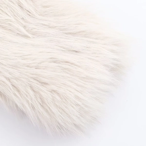 Detailed close-up of fluffy cream faux fur fabric texture for chic winter outerwear