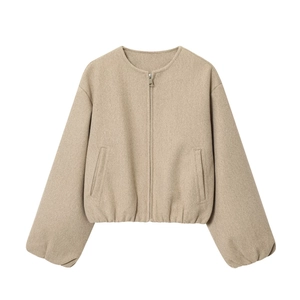 Detailed close-up of khaki bomber jacket featuring a metal zipper and soft textured fabric