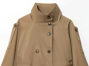 Detail of khaki trench coat funnel neck with double-breasted tortoiseshell buttons