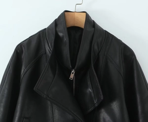 Close-up of black PU leather jacket featuring large lapels and silver metal zippers