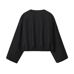 Detail view of the soft black cropped bomber jacket back showing elastic hem and clean seams