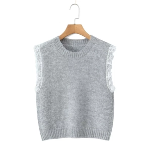 Close-up of grey knit vest featuring delicate white lace trim on the armholes