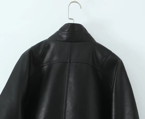 Detail of a matte black PU leather jacket showing the stand collar and stitch work