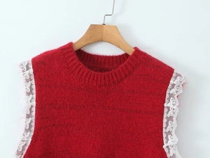 Close-up of red knit vest featuring delicate white butterfly lace trim on sleeves
