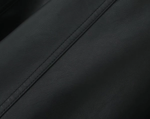 Detailed close-up showing the double stitching on premium black pebble grain PU leather jacket