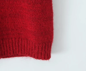 Detailed close-up of dark red mohair knit vest featuring premium ribbed hem texture