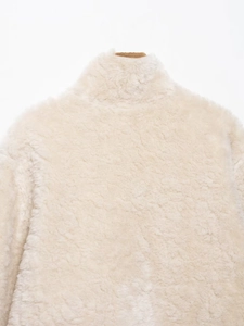 Detailaufnahme des Rückenkragens und der cremefarbenen Fleece-Struktur der Wendejacke