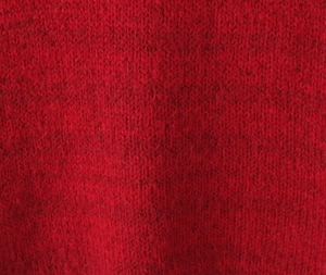 Macro shot showing the soft texture and fine knit stitch of the deep red wool blend fabric