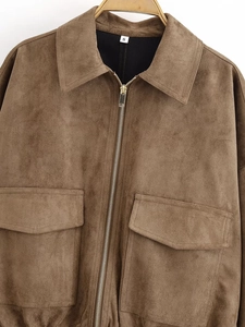 Detail showing the brown suede texture, oversized flap pockets, and zipper on jacket