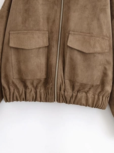 Detail of brown faux suede jacket featuring metal zipper and large utility pockets