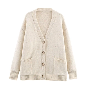 Close-up of cream V-neck knit cardigan featuring colorful nep yarn and brown buttons