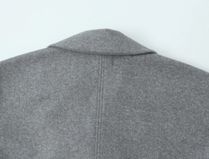 Detail of the high-quality grey wool fabric with precise double-needle stitching on the collar