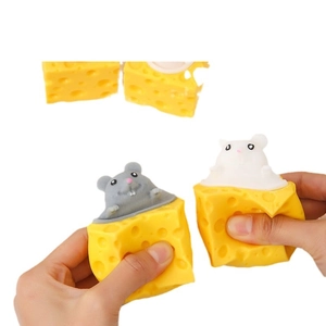 Cheese squeeze toy with grey and white mouse popping out from a yellow block