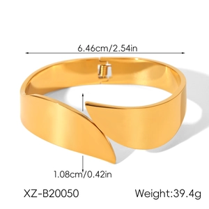 Detail view of the wide gold stainless steel bangle with its hinged opening mechanism