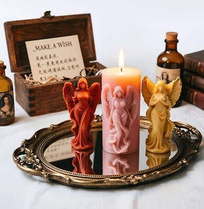 Detailed view of angel shaped candles and embossed pillars on a vintage metal tray
