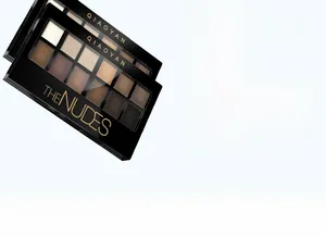 Macro shot of 12-color nude eyeshadow palette featuring matte and shimmer earth tones