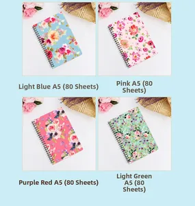 Four colorful A5 spiral notebooks with floral watercolor patterns and metal binding