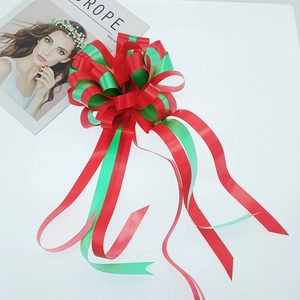 Christmas gift bow made of red and green satin ribbons for festive holiday packaging