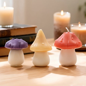 Three creative mushroom shaped scented candles with colorful caps on a rustic wooden table