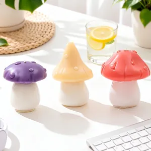 Three colorful mushroom-shaped scented candles in purple, yellow, and coral pink for home decor