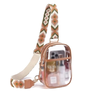 Clear PVC crossbody bag with stylish patterned strap and brown leather trim for stadium use