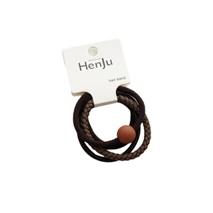 Set of 3 minimalist brown hair ties on a white card including woven and textured styles